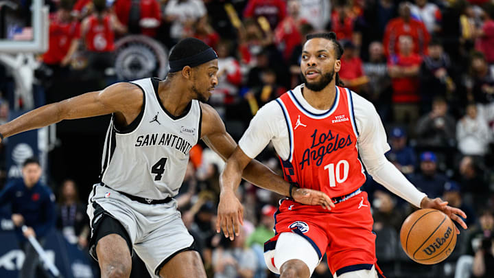 Apr 2, 2026; Inglewood, California, USA; Los Angeles Clippers guard Darius Garland (10) drives the ball while under pressure from San Antonio Spurs guard De'aaron Fox (4) during the first half at Intuit Dome. Mandatory Credit: William Liang-Imagn Images