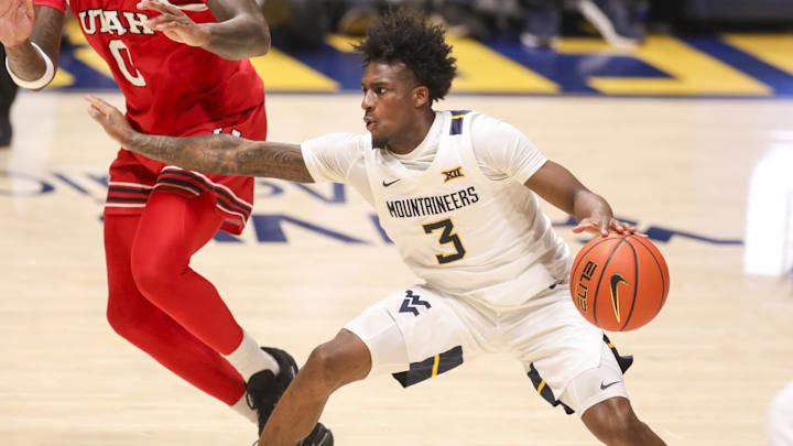 Feb 18, 2026; Morgantown, West Virginia, USA; West Virginia Mountaineers guard Honor Huff (3) dribbles against Utah Utes forward Seydou Traore (0) during the first half at Hope Coliseum. Mandatory Credit: Ben Queen-Imagn Images