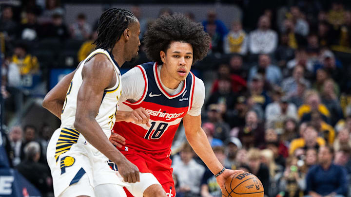 Apr 8, 2025; Indianapolis, Indiana, USA; Washington Wizards forward Kyshawn George (18) dribbles the ball while Indiana Pacers forward Aaron Nesmith (23) defends in the second half at Gainbridge Fieldhouse. Mandatory Credit: Trevor Ruszkowski-Imagn Images
