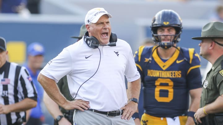 Sep 13, 2025; Morgantown, West Virginia, USA; West Virginia Mountaineers head coach Rich Rodriguez yells at the referee during the second quarter against the Pittsburgh Panthers at Milan Puskar Stadium. Mandatory Credit: Ben Queen-Imagn Images