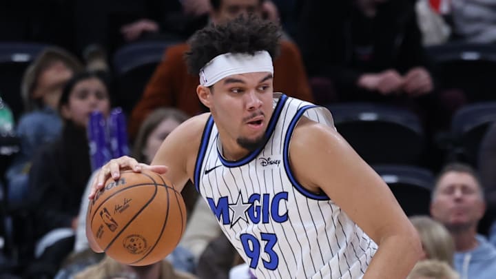 Dec 20, 2025; Salt Lake City, Utah, USA; Orlando Magic forward Noah Penda (93) backs the ball toward the basket against Utah Jazz guard Keyonte George (3) during the second half at Delta Center. Mandatory Credit: Rob Gray-Imagn Images