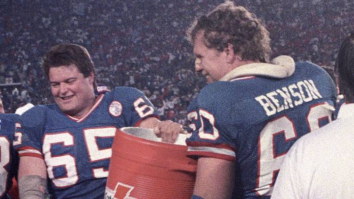 Jan 25, 1987; Pasadena, CA, USA; FILE PHOTO; New York Giants center Bart Oates (left) and tackle Brad Benson (right) hold a gatorade bucket during Super Bowl XXI against the Denver Broncos at the Rose Bowl. The Giants defeated the Broncos 39-20.  