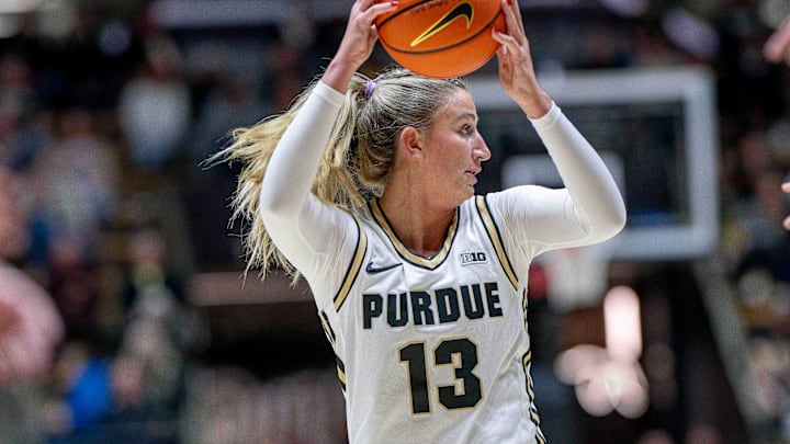 Purdue junior Saige Stahl (13) looks for a lane through traffic.