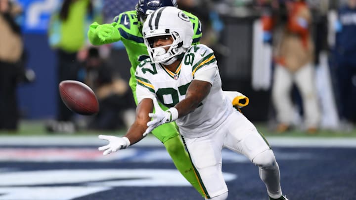 Dec 15, 2024; Seattle, Washington, USA; Green Bay Packers wide receiver Romeo Doubs (87) catches a pass for a touchdown while covered by Seattle Seahawks cornerback Devon Witherspoon (21) during the second half at Lumen Field. Mandatory Credit: Steven Bisig-Imagn Images Dec 15, 2024; Seattle, Washington, USA; Green Bay Packers wide receiver Romeo Doubs (87) catches a pass for a touchdown while covered by Seattle Seahawks cornerback Devon Witherspoon (21) during the second half at Lumen Field. Mandatory Credit: Steven Bisig-Imagn Images