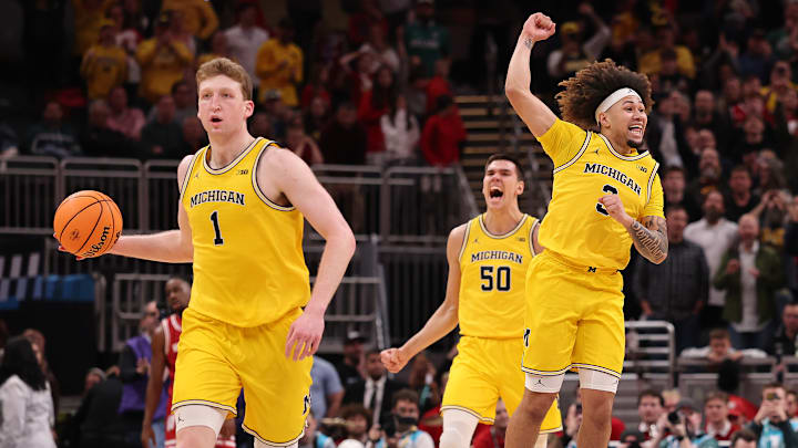 Danny Wolf #1, Tre Donaldson #3 and Vladislav Goldin #50 of the Michigan Wolverines celebrate after winning the Big Ten men's basketball tournament championship at Gainbridge Fieldhouse on March 16, 2025 in Indianapolis, Indiana.