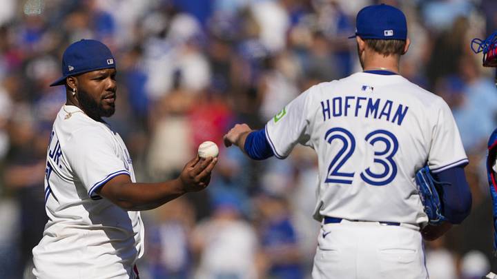Aug 31, 2025; Toronto, Ontario, CAN; Toronto Blue Jays first base Vladimir Guerrero Jr. (27) gives pitcher Jeff Hoffman (23) a ball after defeating the Milwaukee Brewers at Rogers Centre. Mandatory Credit: Kevin Sousa-Imagn Images