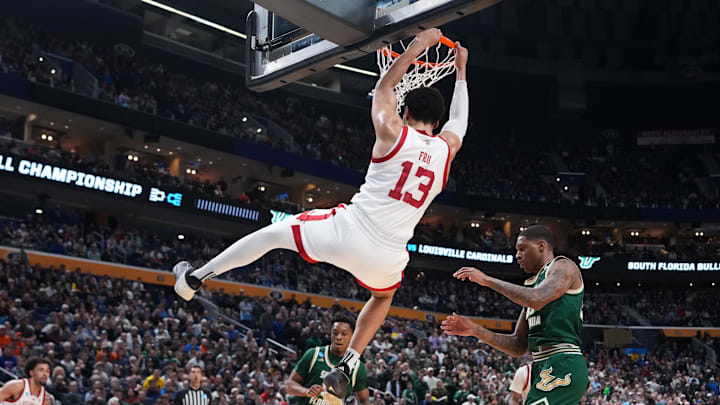 Mar 19, 2026; Buffalo, NY, USA; Louisville Cardinals forward Sananda Fru (13) makes a slam dunk during the second half against the South Florida Bulls during a first round game of the men's 2026 NCAA Tournament at Keybank Center. Mandatory Credit: Gregory Fisher-Imagn Images