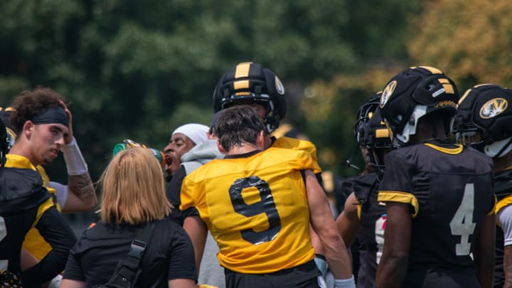 Aug 6, 2025; Columbia, MO, USA; Missouri Tigers quarterback Beau Pribula (9) stands in front of fellow quarterback Sam Horn (21) and talks with the team at the conclusion of a fall camp practice at Mizzou Athletic Training Complex.