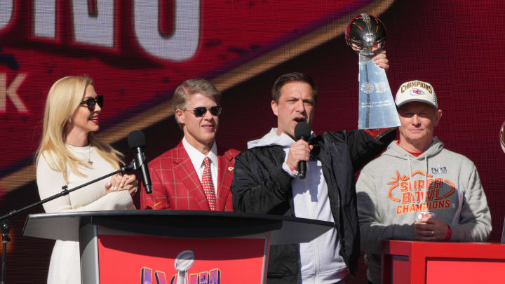 Feb 14, 2024; Kansas City, MO, USA; Kansas City Chiefs general manager Brett Veach speaks as owner Clark Hunt and wife Tavia Hunt and play-by-play announcer Mitch Holthus listen during the celebration of the Chiefs winning Super Bowl LVIII. Mandatory Credit: Kirby Lee-USA TODAY Sports Feb 14, 2024; Kansas City, MO, USA; Kansas City Chiefs general manager Brett Veach speaks as owner Clark Hunt and wife Tavia Hunt and play-by-play announcer Mitch Holthus listen during the celebration of the Chiefs winning Super Bowl LVIII. Mandatory Credit: Kirby Lee-USA TODAY Sports