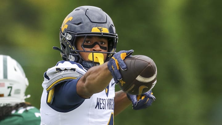Sep 6, 2025; Athens, Ohio, USA; West Virginia Mountaineers wide receiver Cam Vaughn (4) celebrates a first down after a catch during the first quarter against the Ohio Bobcats at Peden Stadium. Mandatory Credit: Ben Queen-Imagn Images