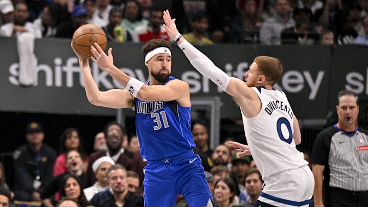 Dec 25, 2024; Dallas, Texas, USA; Dallas Mavericks guard Klay Thompson (31) passes the ball by Minnesota Timberwolves guard Donte DiVincenzo (0) during the second quarter at the American Airlines Center. Mandatory Credit: Jerome Miron-Imagn Images Dec 25, 2024; Dallas, Texas, USA; Dallas Mavericks guard Klay Thompson (31) passes the ball by Minnesota Timberwolves guard Donte DiVincenzo (0) during the second quarter at the American Airlines Center. Mandatory Credit: Jerome Miron-Imagn Images