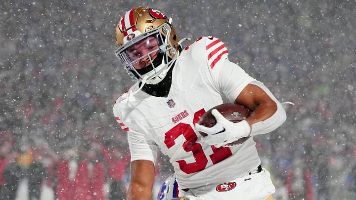 Dec 1, 2024; Orchard Park, New York, USA; San Francisco 49ers running back Isaac Guerendo (31) runs with the ball for a touchdown against Buffalo Bills safety Damar Hamlin (3) during the second half at Highmark Stadium. Mandatory Credit: Gregory Fisher-Imagn Images