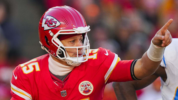 Dec 14, 2025; Kansas City, Missouri, USA; Kansas City Chiefs quarterback Patrick Mahomes (15) scrambles against Los Angeles Chargers linebacker Odafe Oweh (98) during the second half at GEHA Field at Arrowhead Stadium. Mandatory Credit: Jay Biggerstaff-Imagn Images