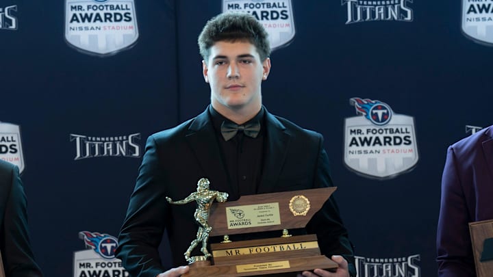 Division II - Class A 2024 Tennessee Titans Mr. Football Jared Curtis, Nashville Christian School, center, is flanked by finalists Nix Cullen, Tipton-Rosemark Academy, left, and Jay'len Mosley, Jackson Christian School, during the Titans Mr. Football Awards at Nissan Stadium in Nashville, Tenn., Tuesday, Dec. 10, 2024.