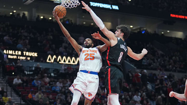 Mar 12, 2025; Portland, Oregon, USA; New York Knicks small forward Mikal Bridges (25) shoots the ball against Portland Trail Blazers small forward Deni Avdija (8) during the second half at Moda Center. Mandatory Credit: Soobum Im-Imagn Images
