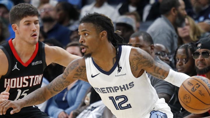 Nov 5, 2025; Memphis, Tennessee, USA; Memphis Grizzlies guard Ja Morant (12) dribbles as Houston Rockets guard Reed Sheppard (15) defends during the fourth quarter at FedExForum. Mandatory Credit: Petre Thomas-Imagn Images