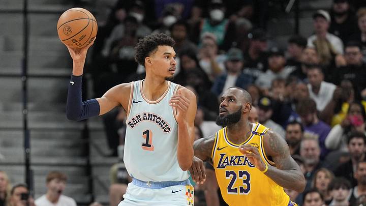 Nov 27, 2024; San Antonio, Texas, USA;  San Antonio Spurs center Victor Wembanyama (1) handles the ball in front of Los Angeles Lakers forward LeBron James (23) in the second half at Frost Bank Center. Mandatory Credit: Daniel Dunn-Imagn Images