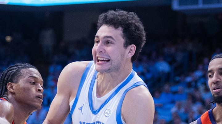 Mar 3, 2026; Chapel Hill, North Carolina, USA; Clemson Tigers forward RJ Godfrey (0) ties up the ball with North Carolina Tar Heels guard Luka Bogavac (44) during the second half at Dean E. Smith Center. Mandatory Credit: Scott Kinser-Imagn Images