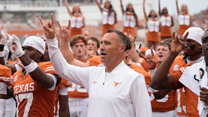 Texas Longhorns head coach Steve Sarkisian and players hold up their horns with the fans during the singing of the Eyes of Texas. Texas Longhorns head coach Steve Sarkisian and players hold up their horns with the fans during the singing of the Eyes of Texas.