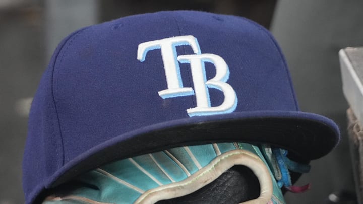 Sep 26, 2025; Toronto, Ontario, CAN; The hat and glove of Tampa Bay Rays third baseman Junior Caminero (13) in the dugout during the game against the Toronto Blue Jays at Rogers Centre. 