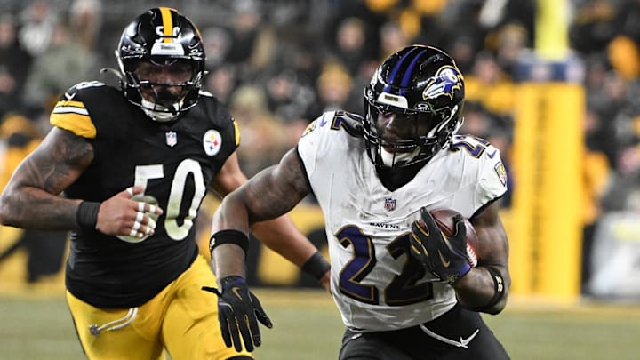 Jan 4, 2026; Pittsburgh, Pennsylvania, USA; Baltimore Ravens running back Derrick Henry (22) rushes the ball past Pittsburgh Steelers linebacker Malik Harrison (50) during the first half at Acrisure Stadium. Mandatory Credit: Barry Reeger-Imagn Images