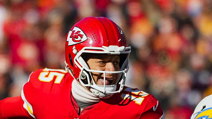 Dec 14, 2025; Kansas City, Missouri, USA; Kansas City Chiefs quarterback Patrick Mahomes (15) scrambles against Los Angeles Chargers safety Tony Jefferson (23) during the first half at GEHA Field at Arrowhead Stadium. Mandatory Credit: Jay Biggerstaff-Imagn Images