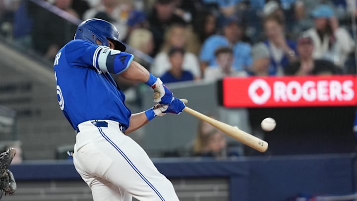 May 20, 2025; Toronto, Ontario, CAN; Toronto Blue Jays designated hitter Anthony Santander (25) hits a two-run home run against the San Diego Padres during the fifth inning at Rogers Centre. 