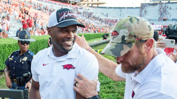 Arkansas Razorbacks defensive coordinator and former Auburn player and coach Travis Williams cheers with fans as he walks off the field Arkansas Razorbacks defensive coordinator and former Auburn player and coach Travis Williams cheers with fans as he walks off the field