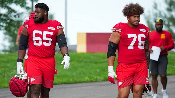 Jul 22, 2025; St. Joseph, MO, USA; Kansas City Chiefs guard Trey Smith (65) and offensive tackle Kingsley Suamataia (76) walk down the hill to the practice fields during training camp at Missouri Western State University. Mandatory Credit: Denny Medley-Imagn Images
