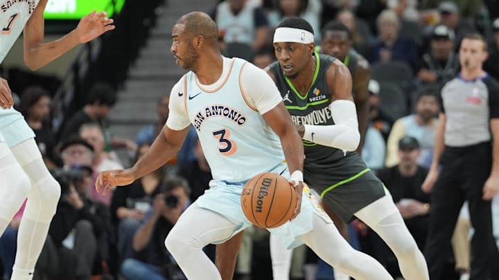 San Antonio Spurs guard Chris Paul (3) dribbles against Minnesota Timberwolves forward Jaden McDaniels (3) in the first half at Frost Bank Center. San Antonio Spurs guard Chris Paul (3) dribbles against Minnesota Timberwolves forward Jaden McDaniels (3) in the first half at Frost Bank Center.