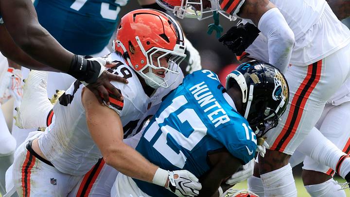Jacksonville Jaguars wide receiver Travis Hunter is tackled by Cleveland Browns linebacker Carson Schwesinger.