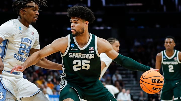 Michigan State forward Malik Hall (25) dribbles against North Carolina forward Jae'Lyn Withers (24) during the first half of the NCAA tournament West Region second round at Spectrum Center in Charlotte, N.C. on Saturday, March 23, 2024. Michigan State forward Malik Hall (25) dribbles against North Carolina forward Jae'Lyn Withers (24) during the first half of the NCAA tournament West Region second round at Spectrum Center in Charlotte, N.C. on Saturday, March 23, 2024.