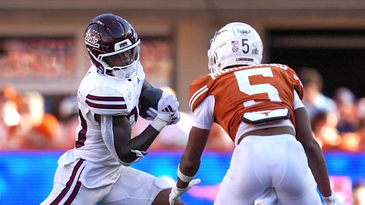 Mississippi State Bulldogs running back Johnnie Daniels (20) runs in front of Texas Longhorns defensive back Malik Muhammad (5) in the second half at Darrell K Royal-Texas Memorial Stadium.