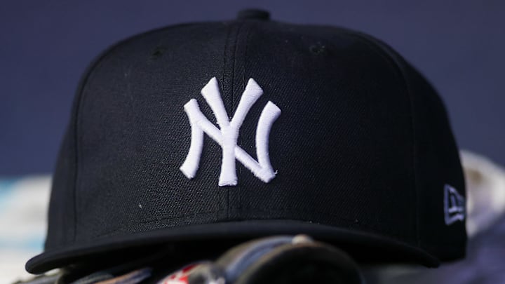 Aug 14, 2023; Atlanta, Georgia, USA; A detailed view of a New York Yankees hat and glove on the bench against the Atlanta Braves in the third inning at Truist Park. Aug 14, 2023; Atlanta, Georgia, USA; A detailed view of a New York Yankees hat and glove on the bench against the Atlanta Braves in the third inning at Truist Park.
