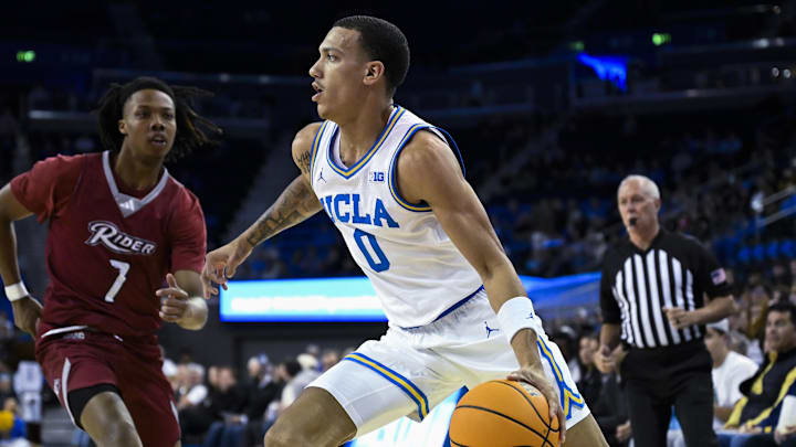 Nov 4, 2024; Los Angeles, California, USA; UCLA Bruins guard Kobe Johnson (0) drives the baseline past Rider Broncs forward Ife West-Ingram (7) during the first half at Pauley Pavilion presented by Wescom. Mandatory Credit: Robert Hanashiro-Imagn Images Nov 4, 2024; Los Angeles, California, USA; UCLA Bruins guard Kobe Johnson (0) drives the baseline past Rider Broncs forward Ife West-Ingram (7) during the first half at Pauley Pavilion presented by Wescom. Mandatory Credit: Robert Hanashiro-Imagn Images