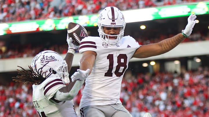 Mississippi State Bulldogs running back Davon Booth (21) celebrates after a touchdown with tight end Seydou Traore (18) against the Georgia Bulldogs in the third quarter at Sanford Stadium.