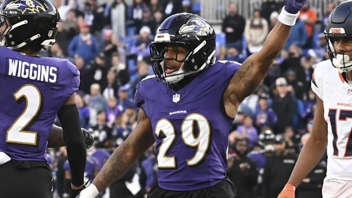 Nov 3, 2024; Baltimore, Maryland, USA; Baltimore Ravens cornerback Nate Wiggins (2) and =safety Ar'Darius Washington (29) celebrate after tackling Denver Broncos wide receiver Courtland Sutton (14) on the one yard line on fourth down  the  during the  half at M&T Bank Stadium. Mandatory Credit: Tommy Gilligan-Imagn Images