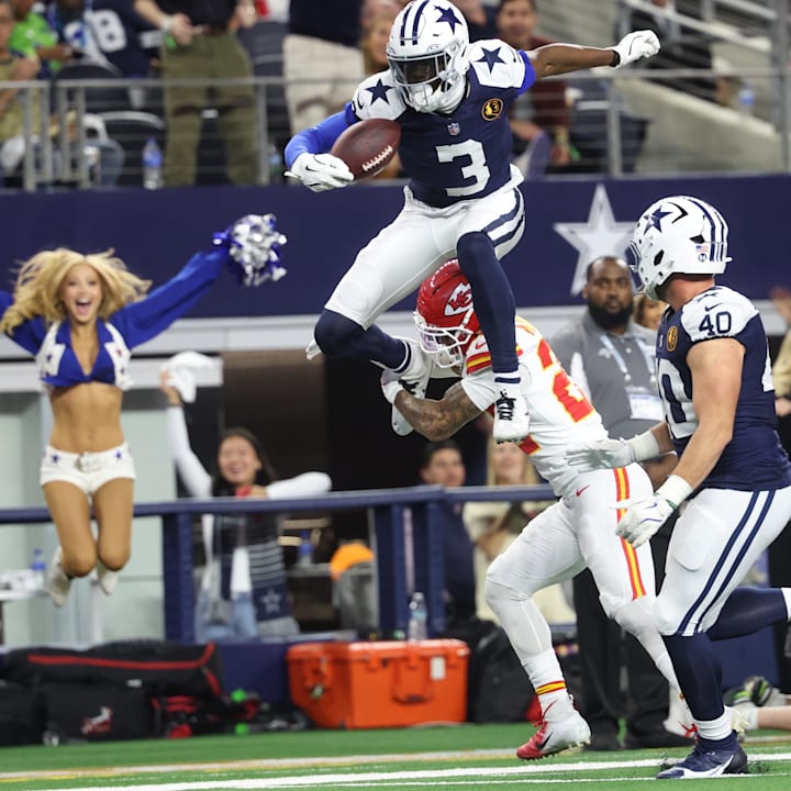 Dallas Cowboys wide receiver George Pickens hurdles Kansas City Chiefs cornerback Trent McDuffie 