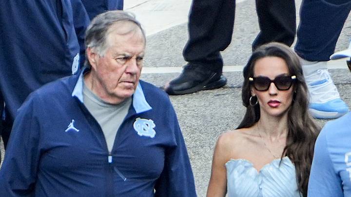 University of North Carolina Head Coach Bill Belichick and Jordon Hudson get off the bus. University of North Carolina Head Coach Bill Belichick and Jordon Hudson get off the bus.