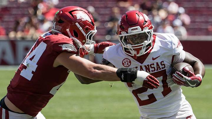 Arkansas Razorbacks running back Cam Settles (27) tries to get around linebacker Ben Bogle (44) during the spring game at Razorback Stadium. Arkansas Razorbacks running back Cam Settles (27) tries to get around linebacker Ben Bogle (44) during the spring game at Razorback Stadium.
