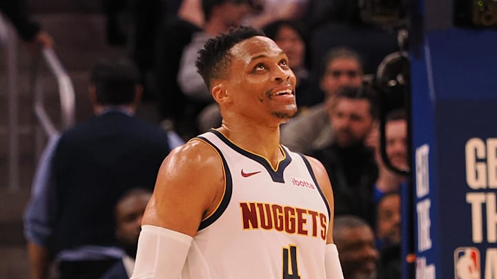 Mar 17, 2025; San Francisco, California, USA; Denver Nuggets guard Russell Westbrook (4) smiles ahead of a sign reading “Russ” after a play against the Golden State Warriors during the fourth quarter at Chase Center. Mandatory Credit: Kelley L Cox-Imagn Images Mar 17, 2025; San Francisco, California, USA; Denver Nuggets guard Russell Westbrook (4) smiles ahead of a sign reading “Russ” after a play against the Golden State Warriors during the fourth quarter at Chase Center. Mandatory Credit: Kelley L Cox-Imagn Images