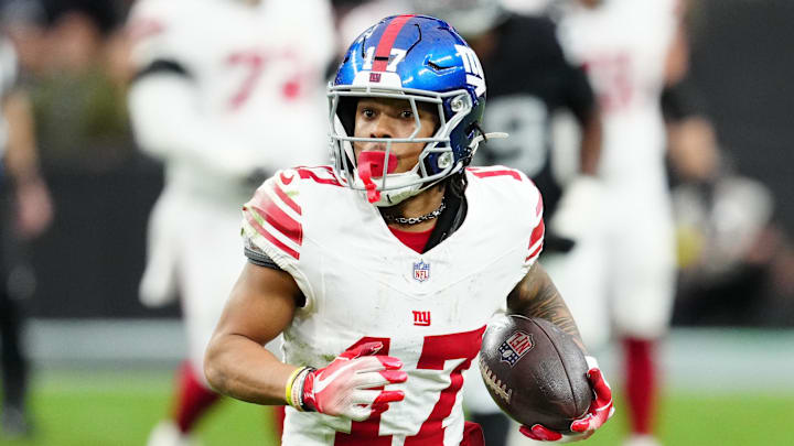 Dec 28, 2025; Paradise, Nevada, USA; New York Giants wide receiver Wan'Dale Robinson (17) runs with the ball after a catch in the second quarter against the Las Vegas Raiders at Allegiant Stadium.  