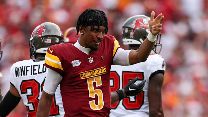 Sep 8, 2024; Tampa, Florida, USA; Washington Commanders quarterback Jayden Daniels (5) reacts after a first down against the Tampa Bay Buccaneers in the second quarter at Raymond James Stadium. Mandatory Credit: Nathan Ray Seebeck-Imagn Images