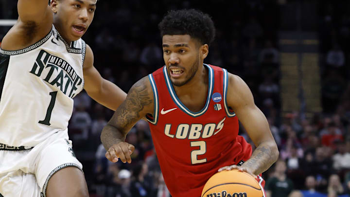 Mar 23, 2025; Cleveland, OH, USA; New Mexico Lobos guard Donovan Dent (2) dribbles the ball defended by Michigan State Spartans guard Jeremy Fears Jr. (1) in the second half during the NCAA Tournament Second Round at Rocket Arena. Mandatory Credit: Rick Osentoski-Imagn Images Mar 23, 2025; Cleveland, OH, USA; New Mexico Lobos guard Donovan Dent (2) dribbles the ball defended by Michigan State Spartans guard Jeremy Fears Jr. (1) in the second half during the NCAA Tournament Second Round at Rocket Arena. Mandatory Credit: Rick Osentoski-Imagn Images