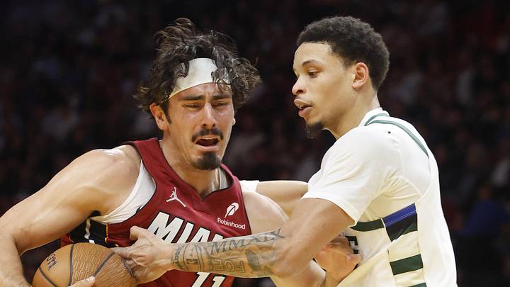 Nov 26, 2025; Miami, Florida, USA; Milwaukee Bucks guard Ryan Rollins (13) defends Miami Heat forward Jaime Jaquez Jr. (11) during the second half of an NBA Cup game at Kaseya Center. Mandatory Credit: Rhona Wise-Imagn Images