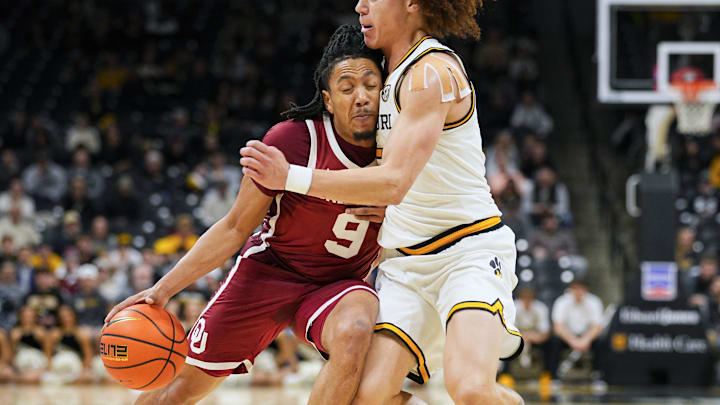 Jan 24, 2026; Columbia, Missouri, USA; Oklahoma Sooners guard Nijel Pack (9) drives against Missouri Tigers guard T.O. Barrett (5) during the second half at Mizzou Arena. Mandatory Credit: Jay Biggerstaff-Imagn Images