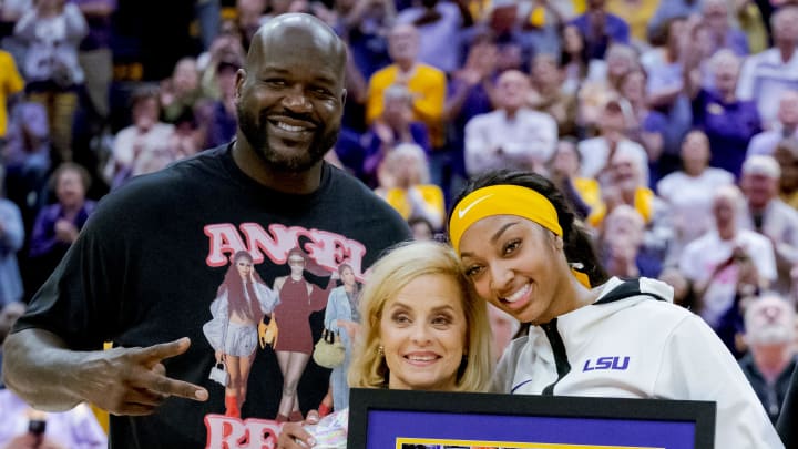 Mar 3, 2024; Baton Rouge, Louisiana, USA; LSU Lady Tigers forward Angel Reese takes a photo for senior night with former LSU player and NBA champion Shaquille O'Neal, LSU Lady Tigers head coach Kim Mulkey, and Reese’s mother Angel Webb against the Kentucky Wildcats at Pete Maravich Assembly Center. 