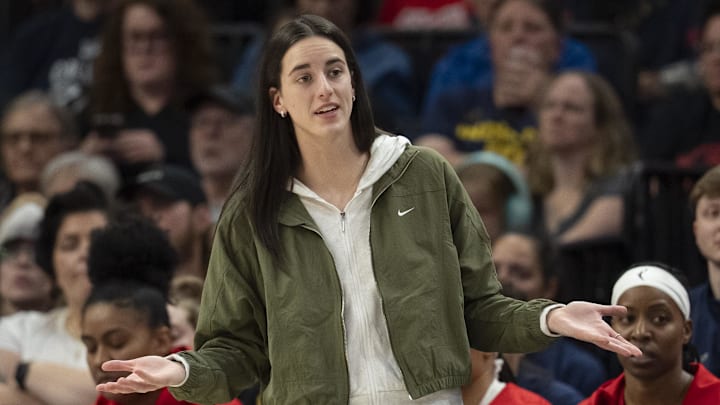 Aug 24, 2025; Minneapolis, Minnesota, USA; Indiana Fever guard Caitlin Clark (22) looks on from the bench against the Minnesota Lynx in the second half at Target Center. Mandatory Credit: Jesse Johnson-Imagn Images