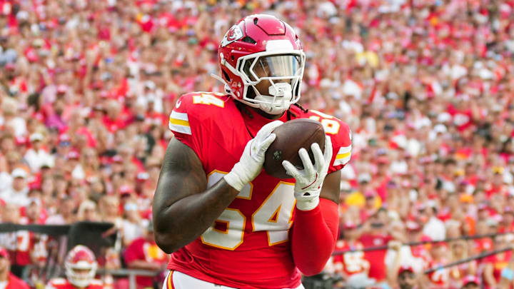 Sep 15, 2024; Kansas City, Missouri, USA; Kansas City Chiefs offensive tackle Wanya Morris (64) catches a touchdown pass during the second half against the Cincinnati Bengals at GEHA Field at Arrowhead Stadium. Mandatory Credit: Jay Biggerstaff-Imagn Images