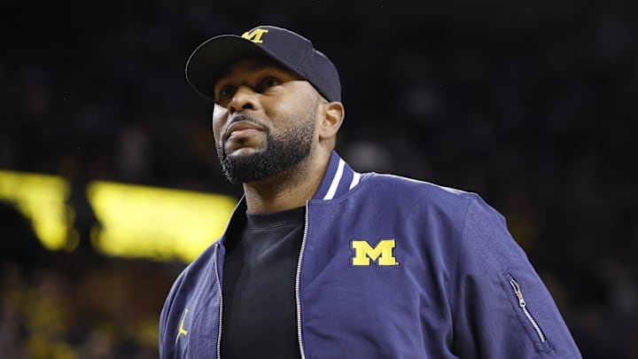 Jan 19, 2025; Ann Arbor, Michigan, USA;  Michigan Wolverines head football coach Sherrone Moore fires up the crowd in overtime of the basketball game against the Northwestern Wildcats at Crisler Center. 